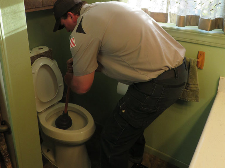 plumber working on toilet clarksville tn